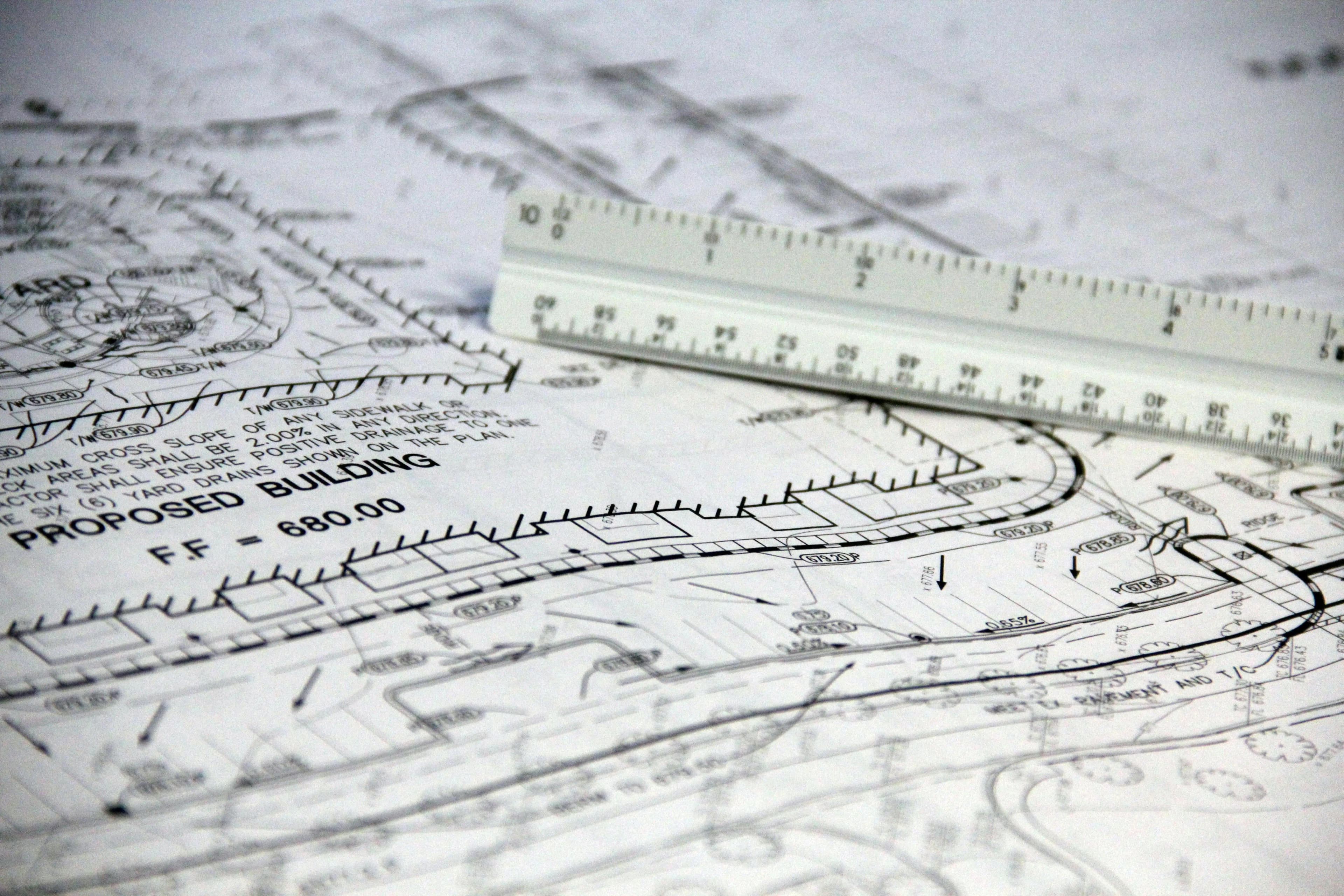 Construction site plan with ruler and pencil — SynqBeam for small contractors